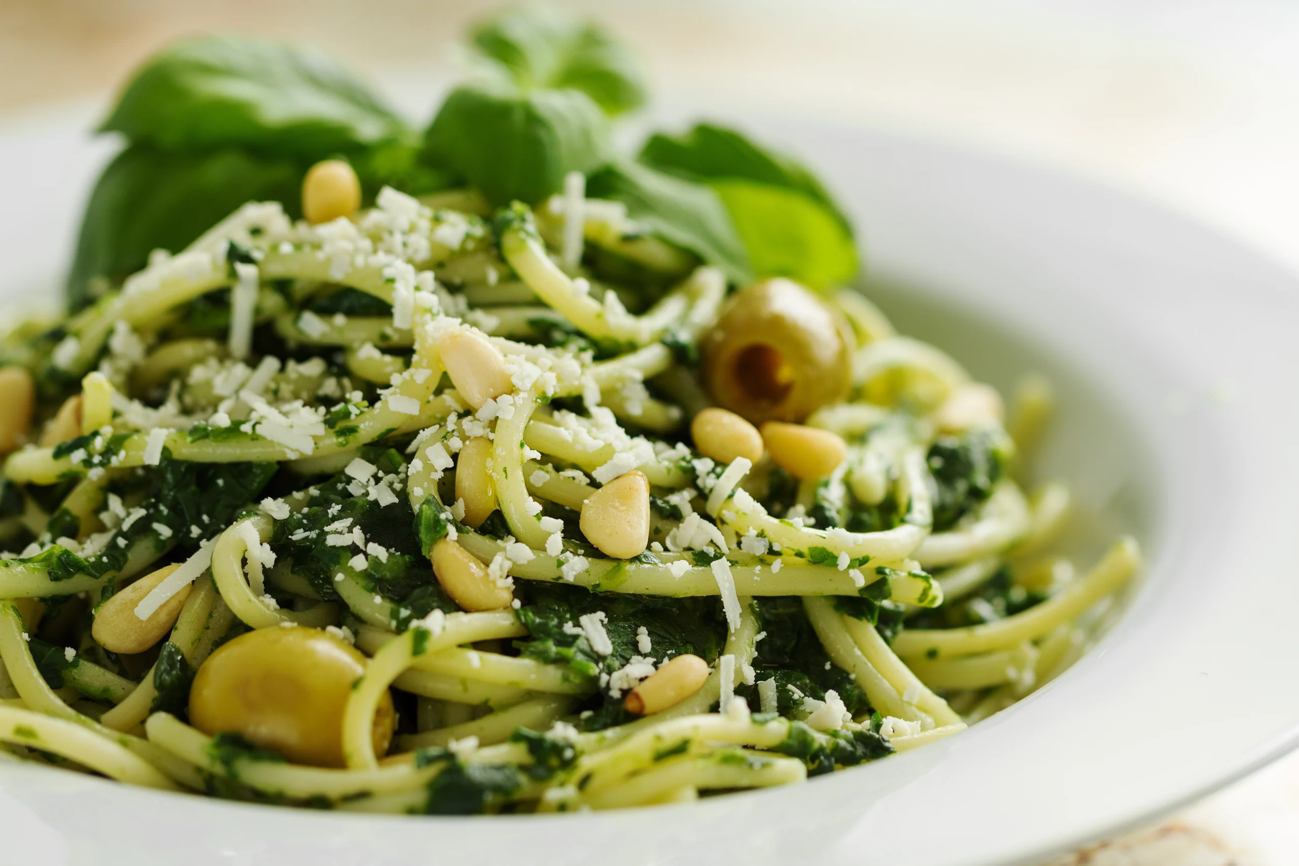 tasty-beautiful-pasta-closeup-with-spinach-cheese-olives-basil-nuts