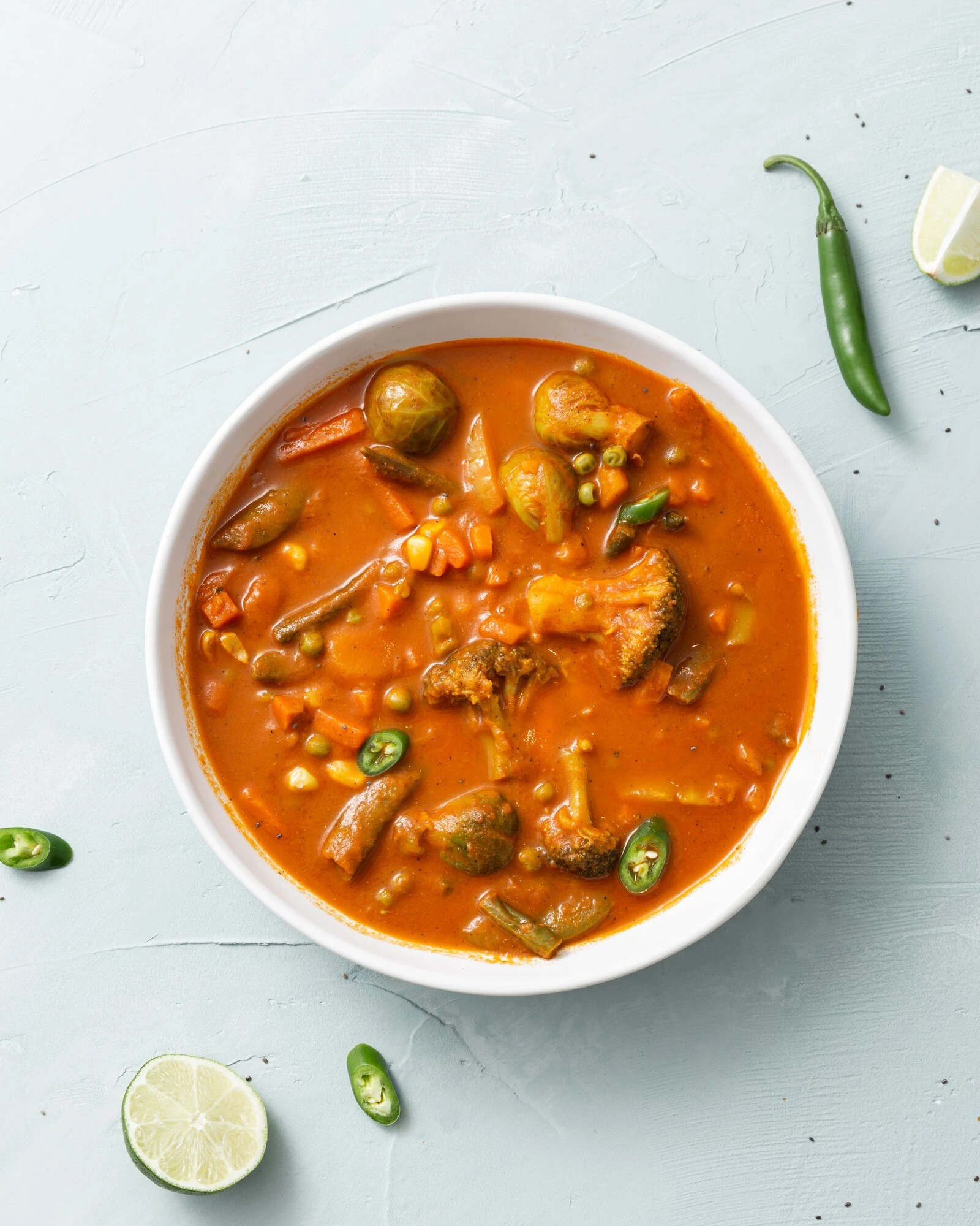 vertical-shot-vegetable-curry-with-cauliflower-beans-corn-spicy-pepper-lime_181624-31901